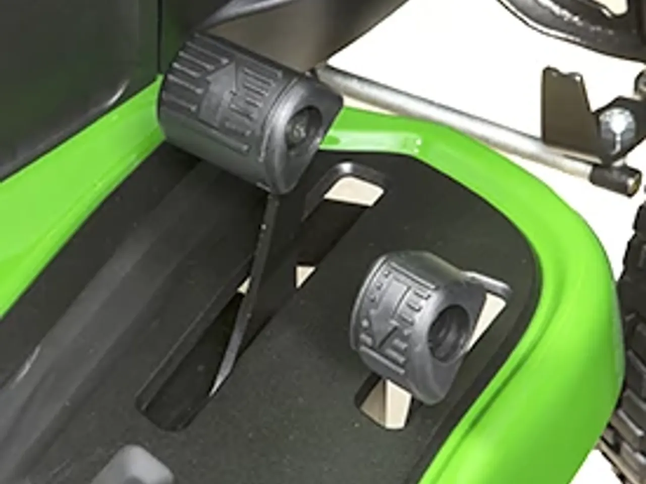 Side-by-side forward and reverse foot pedals of the hydrostatic transmission